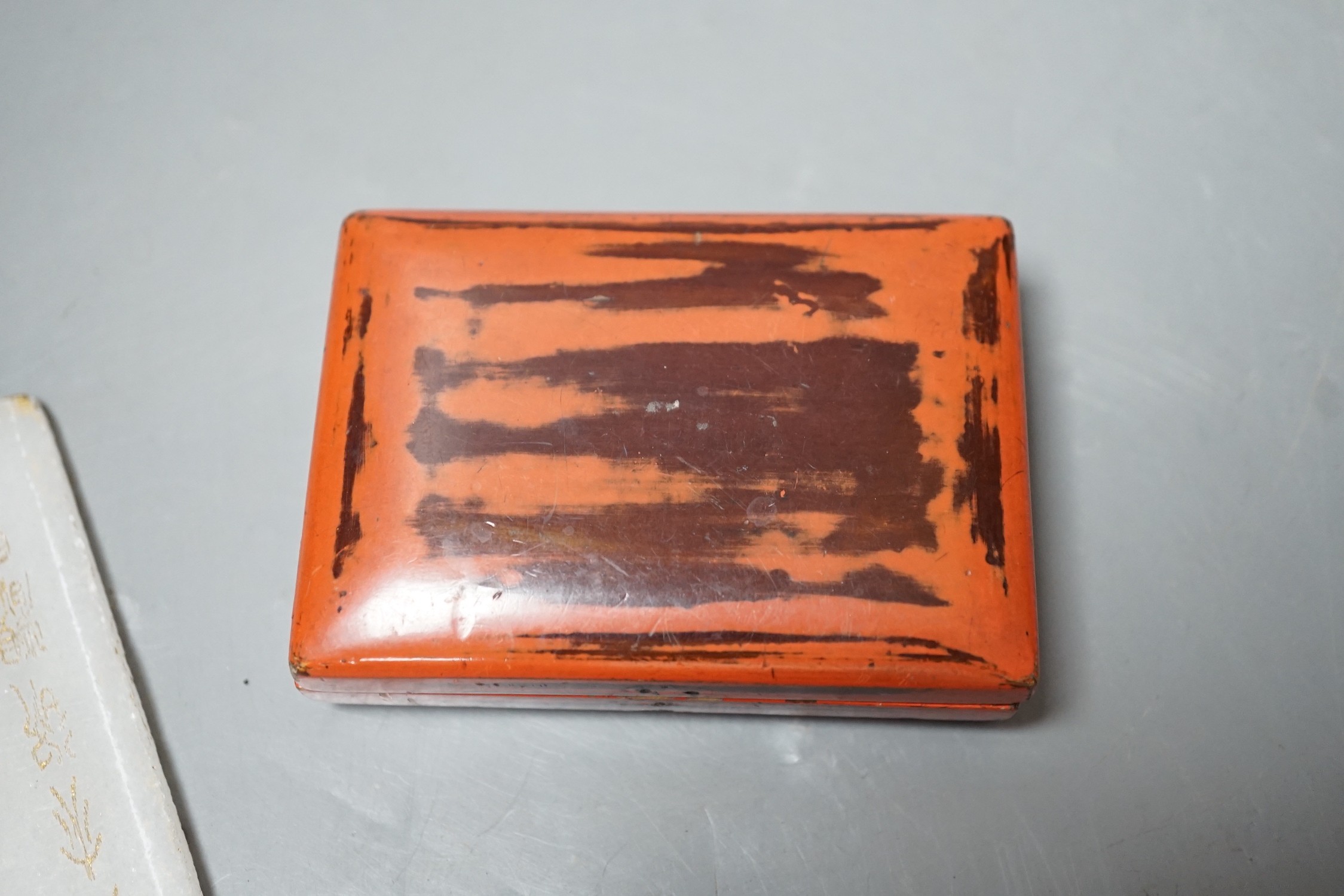 A Chinese hardstone plaque with inscription, 16 x 8cm, together with two lacquer items (3)